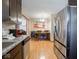 Bright kitchen featuring stainless steel appliances and an adjacent dining area with hardwood flooring at 3538 Whalen Ave, Indianapolis, IN 46227