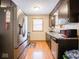 Well-lit kitchen featuring a stainless-steel refrigerator and neutral walls with a window above the sink at 3538 Whalen Ave, Indianapolis, IN 46227