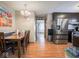 Cozy eat-in kitchen with stainless steel appliances and dark cabinets, illuminated by an elegant chandelier at 3538 Whalen Ave, Indianapolis, IN 46227