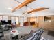 Open-concept living room featuring exposed wood beams and brick accents, providing a warm and inviting atmosphere at 3538 Whalen Ave, Indianapolis, IN 46227