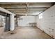 Unfinished basement features painted walls, exposed utilities and concrete floor, offering a blank canvas for customization at 3916 E 10Th St, Indianapolis, IN 46201