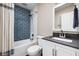 Updated bathroom featuring new vanity, tile backsplash and modern shower head at 3916 E 10Th St, Indianapolis, IN 46201