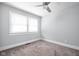 Bright bedroom with neutral carpet, ceiling fan and a window providing plenty of natural light at 3916 E 10Th St, Indianapolis, IN 46201