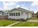 Charming home with gray siding, a screened front porch, and a neatly maintained lawn with pathway at 3916 E 10Th St, Indianapolis, IN 46201
