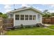 Exterior front view of a charming home with gray siding, a screen door and pathway at 3916 E 10Th St, Indianapolis, IN 46201
