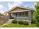 Charming home with a covered front porch, painted brick pillars, and well-maintained front lawn at 3916 E 10Th St, Indianapolis, IN 46201