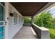 View of a covered front porch with painted brick pillars, and view to a grassy lawn at 3916 E 10Th St, Indianapolis, IN 46201