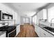 Beautiful kitchen with white cabinets, granite countertops, stainless steel appliances, and wood floors at 3916 E 10Th St, Indianapolis, IN 46201