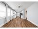 Sunlit open concept living room with hardwood floors flowing into the dining area and kitchen at 3916 E 10Th St, Indianapolis, IN 46201
