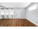 Spacious living room featuring hardwood floors and ample natural light from large windows at 3916 E 10Th St, Indianapolis, IN 46201