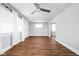 Bright living room featuring hardwood floors, a ceiling fan, and ample natural light from large windows at 3916 E 10Th St, Indianapolis, IN 46201