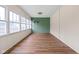 Sunroom with beautiful wood look floors, paneled walls and lots of natural light at 3916 E 10Th St, Indianapolis, IN 46201