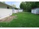 Exterior of home with a backyard featuring green lawn and other buildings, including the garage at 4353 Evanston Ave, Indianapolis, IN 46205