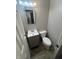 Bathroom features a white vanity and toilet with gray walls and light gray flooring at 4353 Evanston Ave, Indianapolis, IN 46205