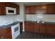 Updated kitchen with stainless steel sink, granite countertops, and new white appliances at 4353 Evanston Ave, Indianapolis, IN 46205