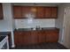 Updated kitchen featuring a stainless steel sink, dark countertops, and tile backsplash at 4353 Evanston Ave, Indianapolis, IN 46205