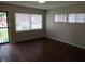 Bright living room with original hardwood floors and natural light from several windows at 4353 Evanston Ave, Indianapolis, IN 46205