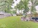 Expansive backyard featuring lush green grass, mature trees, and a patio area, perfect for outdoor entertaining at 4415 N Longworth Ave, Indianapolis, IN 46226