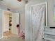 Hallway view showing a room door with pink curtain and closet for an organized space at 4415 N Longworth Ave, Indianapolis, IN 46226