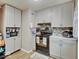 Cozy kitchen featuring gray cabinets, tiled backsplash, and modern appliances creating an efficient cooking space at 4415 N Longworth Ave, Indianapolis, IN 46226