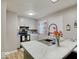 Bright kitchen with a modern faucet, stone countertops, and stainless appliances at 4415 N Longworth Ave, Indianapolis, IN 46226