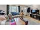 Inviting living room features hardwood floors, a TV, and ample natural light at 4415 N Longworth Ave, Indianapolis, IN 46226