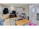 Spacious living room with neutral walls, hardwood floors, and a large television at 4415 N Longworth Ave, Indianapolis, IN 46226
