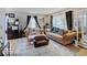 Cozy living room with dark curtains, a large window, and comfortable furniture at 4415 N Longworth Ave, Indianapolis, IN 46226