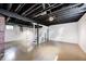 Unfinished basement with painted walls, exposed ceiling and white staircase at 4621 E 17Th St, Indianapolis, IN 46218