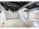 Unfinished basement with painted walls, exposed ceiling and white staircase at 4621 E 17Th St, Indianapolis, IN 46218