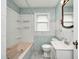 Bathroom with tiled walls and a shower-tub combo with built-in shelves at 4621 E 17Th St, Indianapolis, IN 46218
