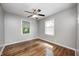 Bedroom with light gray walls, hardwood floors and two windows at 4621 E 17Th St, Indianapolis, IN 46218
