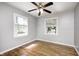 Empty bedroom with two windows, hardwood floors, and a ceiling fan at 4621 E 17Th St, Indianapolis, IN 46218