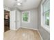 Bedroom featuring two closets, wood look floors and natural light at 4621 E 17Th St, Indianapolis, IN 46218