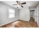 A bedroom features hard wood floors and a ceiling fan at 4621 E 17Th St, Indianapolis, IN 46218