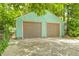 Two-car garage with matching garage doors and a concrete driveway at 4621 E 17Th St, Indianapolis, IN 46218