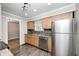 A well-lit kitchen featuring stainless steel appliances and wooden cabinets at 4621 E 17Th St, Indianapolis, IN 46218