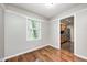Open space featuring hardwood floors, neutral tones, with a view of the kitchen through the doorway at 4621 E 17Th St, Indianapolis, IN 46218