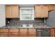 Kitchen with stainless steel appliances, light wood cabinets, and a neutral backsplash at 4621 E 17Th St, Indianapolis, IN 46218