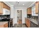 Bright kitchen features dark backsplash and an opening into the hallway at 4621 E 17Th St, Indianapolis, IN 46218