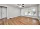 Sunlit living room with polished hardwood floors, ceiling fan, and a bright, inviting atmosphere at 4621 E 17Th St, Indianapolis, IN 46218