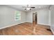 Open room featuring hardwood floors, neutral tones, with a view of the kitchen through the doorway at 4621 E 17Th St, Indianapolis, IN 46218