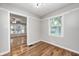 Sunlit room with hardwood floors, neutral tones, with a view of the second living room at 4621 E 17Th St, Indianapolis, IN 46218