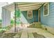 Side porch entry with concrete pad, stairs and metal support structure at 4621 E 17Th St, Indianapolis, IN 46218
