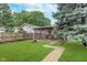 Beautifully landscaped backyard featuring a screened-in patio and a lush green lawn at 4641 Ralston Ave, Indianapolis, IN 46205
