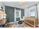 Adorable Bedroom featuring a green accent wall, hardwood floors and two windows at 4641 Ralston Ave, Indianapolis, IN 46205