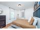 Comfortable bedroom featuring neutral tones, two windows and hardwood floors at 4641 Ralston Ave, Indianapolis, IN 46205