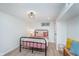 Cozy bedroom with a black metal frame bed, neutral decor, and natural light from the window at 4641 Ralston Ave, Indianapolis, IN 46205