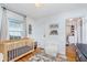 Well-lit Bedroom with hardwood floors, a crib and a comfortable seat at 4641 Ralston Ave, Indianapolis, IN 46205