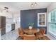 Stylish dining area connects seamlessly to the kitchen, featuring a table, seating, and unique flooring at 4641 Ralston Ave, Indianapolis, IN 46205